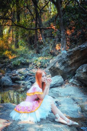 Portrait of asia beautiful girl in ballet dress on natureの写真素材