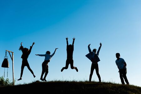 Asai young man and women jumping on hight mountain, Phartang mountain Chiangrai Thailand,  silhouetteの写真素材