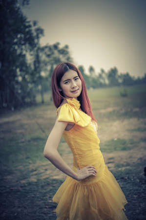 Portrait of Asia Beautiful woman in yellow dress on natureの写真素材