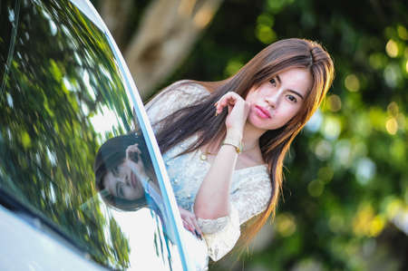 fasion of asia Young girl in dress with luxury motor carの写真素材
