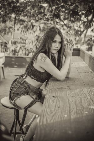 Asia Sexy lady in black shirt and short jeans, vintage effect