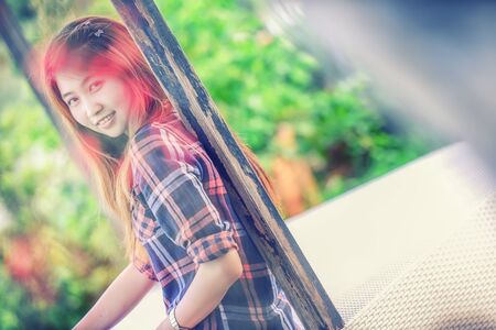 portrait of Asia young Woman in park and looking at camera, vintage effectの写真素材