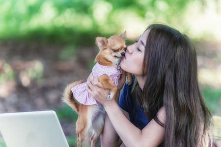 Asia Young happy woman with her dog and laptopの写真素材
