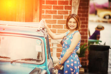 portrait of asia beautiful woman with vintage carの写真素材