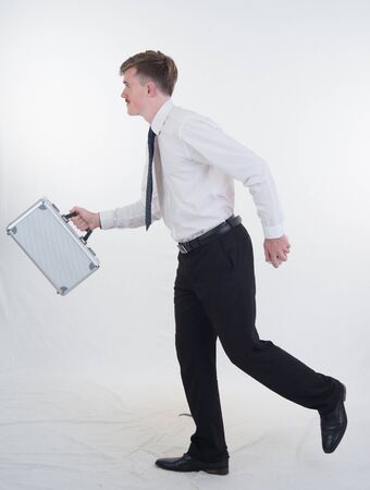 a Business man holding  bag and smatphone on white backgroundの写真素材