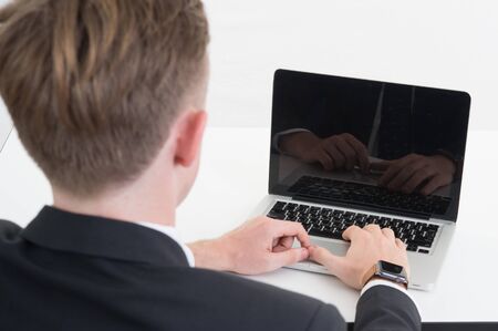 a business man with computer on white backgroundの写真素材
