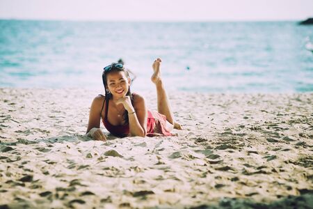 asia Woman on tropical sandy, lying and posing on beachの写真素材