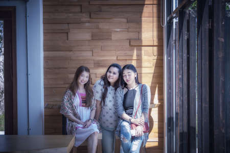portrait of three asia woman in coffee shop near windowの写真素材