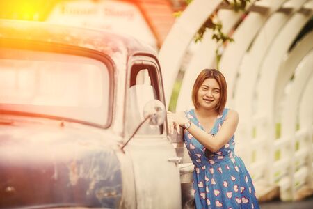 asia beautiful lady standing near vintage carの写真素材
