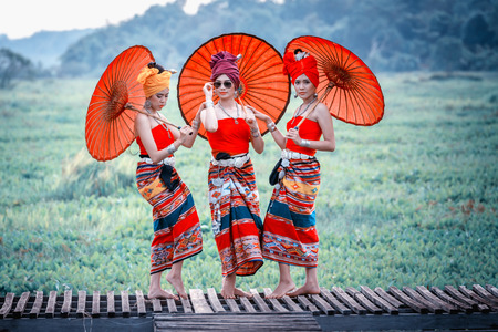 Thai Woman In Traditional Costume with umbrella (thai culture style) on oudoor. Thailand.の写真素材