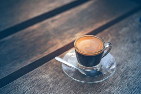 hot coffee on wood table in morning, vintage style, espresso coffee