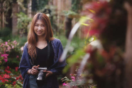 asia beautiful tourist woman take a photo in flower garden at doi angkhang mountain chiangmai Thailandの写真素材
