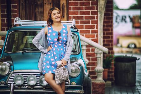 asia beautiful lady standing near vintage carの写真素材