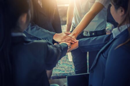 Business people coordinate hands in office. Concept Teamwork.の写真素材