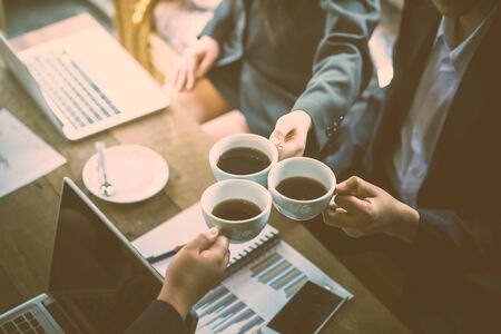 young Businesspeople Group Clinking Cups Coffee Break before meeting to success In Workplace Modern...