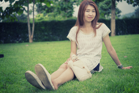 portrait of asia young girl with bag on park, on outdoorの写真素材