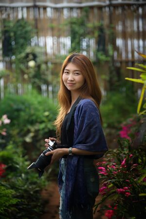 asia beautiful tourist woman take a photo in flower garden at doi angkhang mountain chiangmai Thailandの写真素材