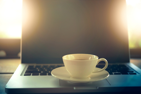 white Coffee cup and laptop for business in cafeの写真素材