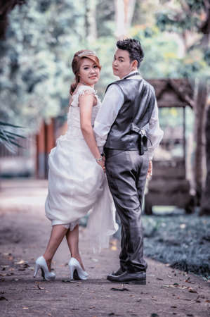 couple in love. portrait of asia young stylish fashion couple posing on outdoor. wedding styleの写真素材