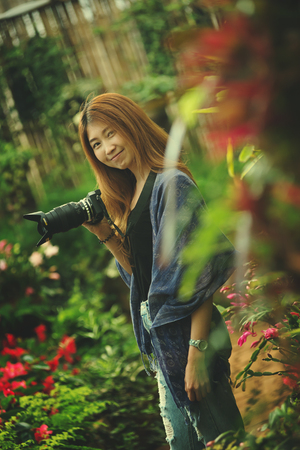 Asia beautiful tourist woman take a photo in flower garden at doi angkhang mountain chiangmai Thailandの写真素材