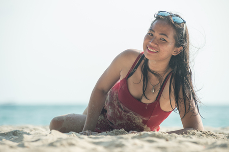 asia Woman on tropical sandy, lying and posing on beachの写真素材