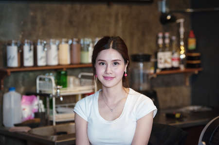 Coffee Business owner Concept - attractive young beautiful caucasian barista in coffee shopの写真素材
