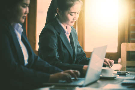 young business woman using laptop in cafe during meetingの写真素材