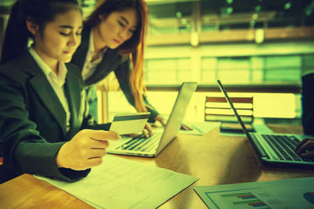 young business woman holding credit card on laptop for online shoppingの写真素材