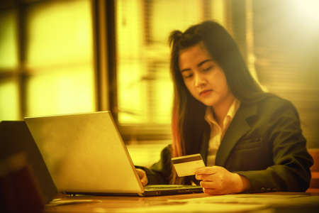 young business woman holding credit card on laptop for online shopping