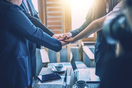 Business people coordinate hands in office. Concept Teamwork.の写真素材