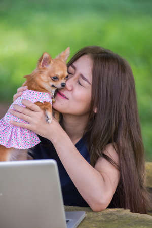 Asia Young happy woman with her dog and laptopの写真素材