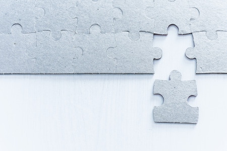Gray puzzle pieces on white backgroundの写真素材