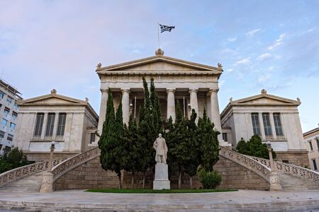 Neoclassical National Library in Athens, Greece, with marble staircase and doric columns.