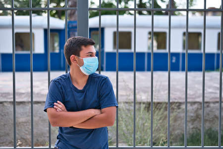Young teen boy wearing face mask outdoor due to the Coronavirus Pandemicの写真素材
