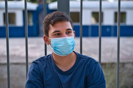 Young teen boy wearing face mask outdoor due to the Coronavirus Pandemicの写真素材