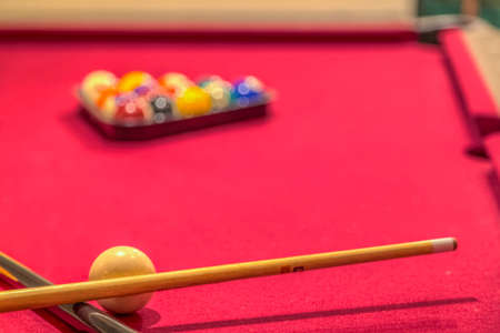 Red billiard table with balls and cue sticksの写真素材