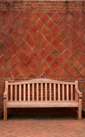 Bench against brick wallの写真素材