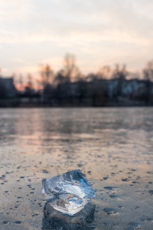 Closeup photo of an icecube on a frozen lake in Belrin during sunriseの写真素材