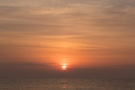 portrait of sun rising over the mediterranean seaの写真素材