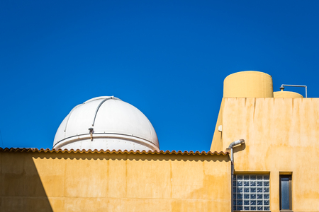 A small telescope dome on a rooftop in spainの写真素材