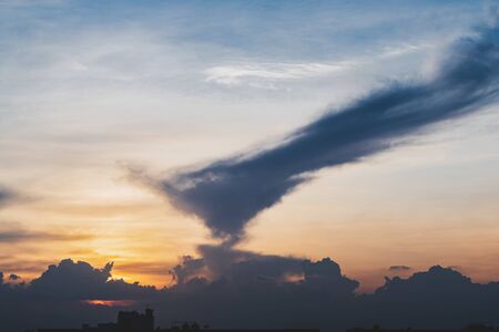 The sky at sunset with clouds are shaped like animals spewing fire.