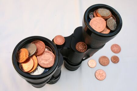 pennies and small change with a pair of binocularsの写真素材