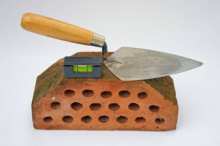 Trowel,spirit level and a brick.の写真素材