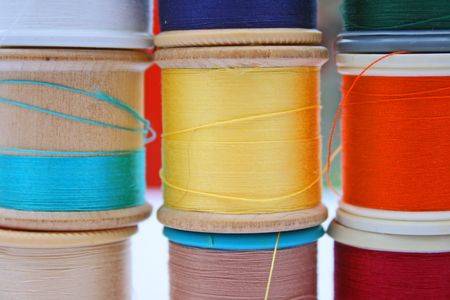 Stack of different coloured cottons on reels