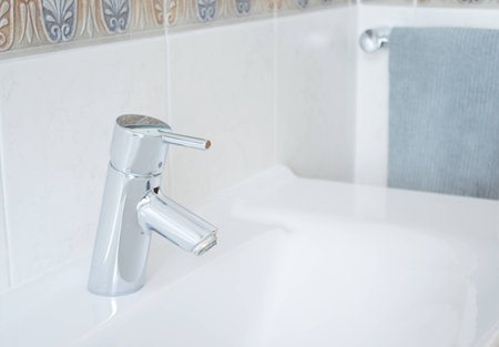 Beautiful, metallic, shiny cap shot in bright scenery in the bathroom の写真素材