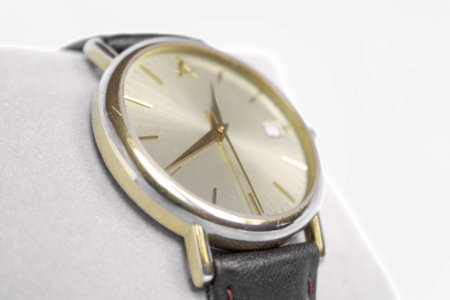 Macro shot of shiny, golden watch with brown, leather belt の写真素材