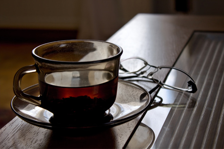 Shot of a tea cup and glasses on the table.の写真素材