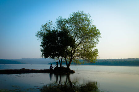 silhouette couple at the lake sideの写真素材