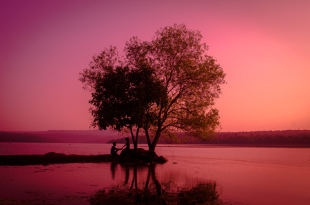 silhouette couple at the lake sideの写真素材