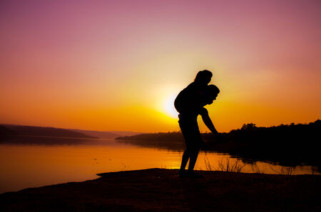 silhouette couple at the lake sideの写真素材